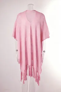 Detailed view of pink oversized hollow knit beach cover-up with fringe tassels