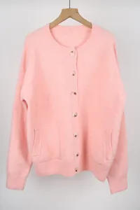 Close-up detail of soft pink crew neck knitted cardigan with button closure and pockets