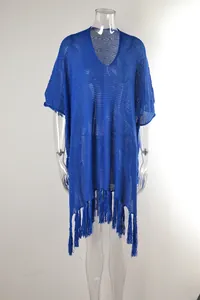 Detailed view of blue hollow-out knit beach cover-up with stylish fringe tassels