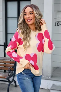 Detail view of women's round neck sweater with vibrant pink floral prints for spring