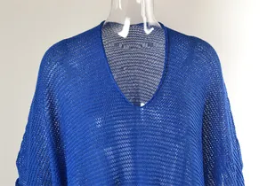 Close-up detail showing the intricate blue crochet mesh fabric and V-neckline of beach cover-up