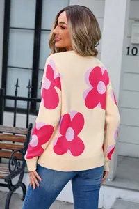 Back view of a cream-colored women's knit sweater featuring large pink flower prints