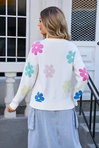 Back view of a white round neck knit sweater featuring colorful floral patterns.