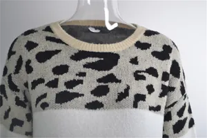 Detailed view of women's leopard print patchwork knit sweater with ribbed crew neck