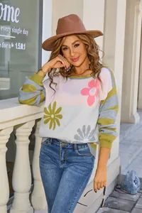 Chic women's round neck sweater with vibrant floral patterns and striped sleeves