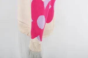 Macro view showing the vibrant floral print and ribbed knit cuff of this women's sweater