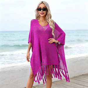 Close-up of vibrant magenta crochet beach cover-up with stylish long tassel fringe detail