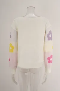 Detailed back view of boat neck knit sweater featuring colorful floral patterns on sleeves