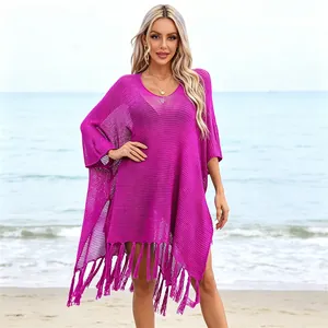 Macro view of vibrant fuchsia crochet beach cover-up with stylish tassel fringe