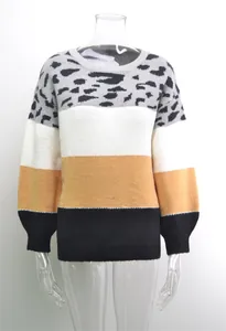 Close-up detail of a women's oversized patchwork leopard print round-neck knit sweater