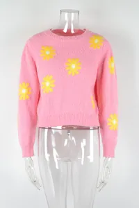 Stylish pink cropped knit sweater featuring yellow daisy flower patterns and crew neck