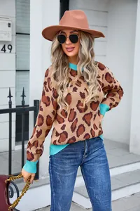 Detailed view of women's leopard print knit sweater featuring vibrant turquoise ribbed trims