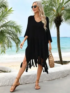 Detail of black hollow-out knit beach cover-up with stylish long tassel fringe