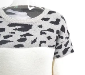 Close-up detail of the stylish leopard print patchwork on a crewneck knit sweater for women.