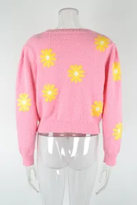 Back view of a pink short-style knitted sweater featuring yellow daisy flower patterns