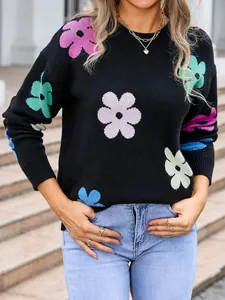 Close-up view of colorful floral pattern on a black round neck knit sweater for women