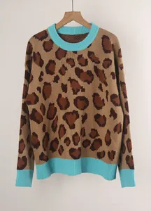 Detailed view of women's leopard print knitted sweater featuring turquoise ribbed trim accents