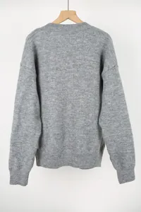Back view of a soft grey crewneck knitted sweater featuring ribbed hem and cuffs detail