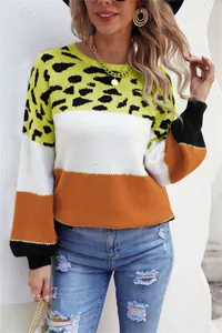 A detailed close-up of a women's round neck knitted sweater with color-blocked leopard print design