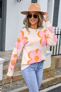 Fashionable crewneck sweater featuring bold pink and orange flower patterns in knit.