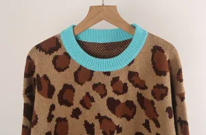 Detail view of women's leopard print knitted sweater with a vibrant turquoise ribbed collar