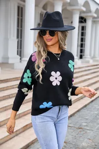 Stylish black long-sleeve knit sweater featuring colorful floral patterns and a classic round neck
