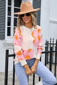 Close-up of women's floral knit sweater with vibrant pink and orange flower patterns