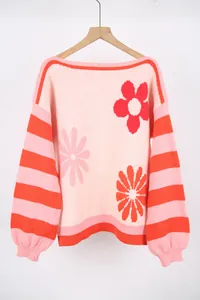 Detailed view of pink floral knit sweater with orange striped sleeves and boat neck