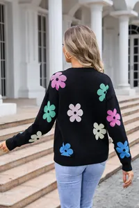Back view of women's black crewneck sweater with colorful flower patterns knit detail