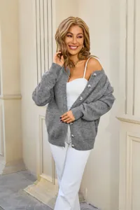 Stylish grey knit cardigan with buttons and pockets shown in an outdoor lifestyle setting.
