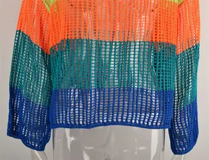 Close-up detail of a vibrant rainbow striped crochet mesh cover-up with long sleeves