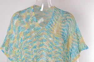 Detalle del vestido de playa de ganchillo con cuello en V y un patrón de punto multicolor