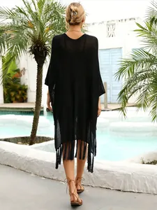 Back view of a black loose-fit crochet beach cover-up with stylish tassels for summer resort