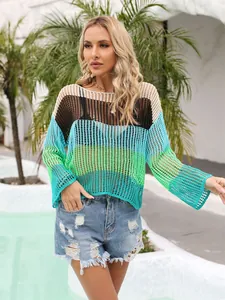 Close-up view of the vibrant rainbow striped hollow-out crochet texture on a knit cover-up