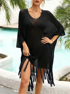 Detailed view of elegant black crochet beach cover-up featuring a stylish tassel hem.