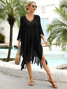 Professional detailed view of black hollow-out knit beach cover-up with stylish fringe hem.