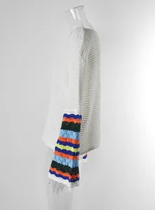 Detail view of the colorful striped bell sleeves on a white crochet beach cover-up
