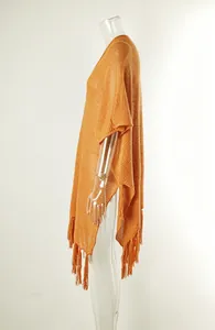 Side view of orange knitted beach cover-up with fringe tassels and hollow out design
