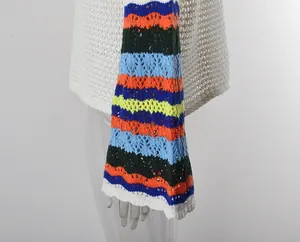 Close-up of colorful striped crochet beach cover-up with hollow knit details.