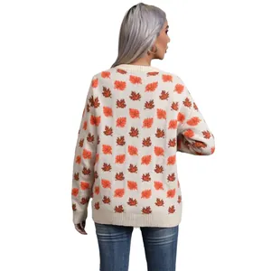 Women's crew neck knit sweater with orange maple leaf pattern, back view, cream