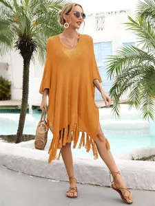 Vibrant orange hollow-out beach cover-up with tassel fringe and loose oversized fit