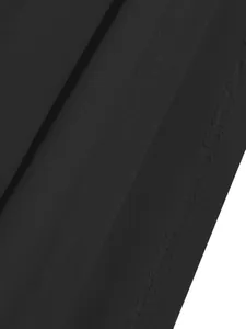 Close-up of the professional stitching and seam detail on the black dress fabric