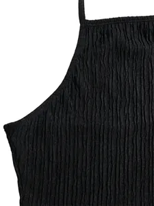 Detailed macro view of black crinkled fabric texture on elegant holiday two-piece set