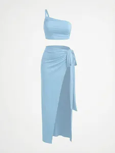Light blue two-piece set featuring one-shoulder crop top and high slit maxi skirt.