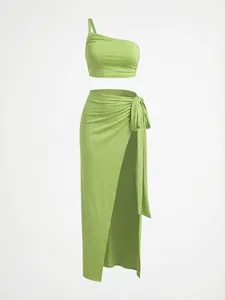 Detailed macro shot of the lime green one-shoulder crop top and high slit skirt set