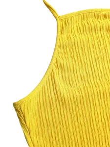 Close-up detail of a bright yellow crinkled fabric halter top with pleated texture