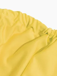 Macro detail of yellow elastic gathered fabric for sexy summer two-piece skirt set