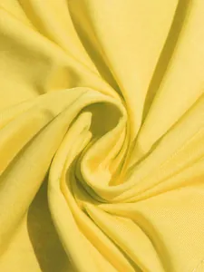 Macro detail of high-quality yellow ribbed fabric showing texture and drape of the dress