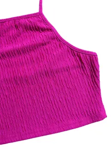 Close-up of magenta crinkled halter crop top showing textured fabric and neckline details.