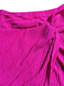 Macro view of vibrant fuchsia pleated fabric texture with elegant crinkled detail